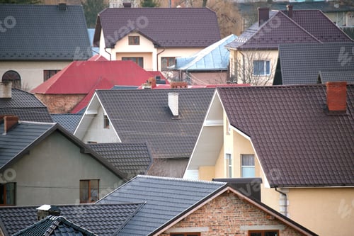 Preview: Residential houses with roof tops covered with metallic and ceramic shingles in rural suburban area