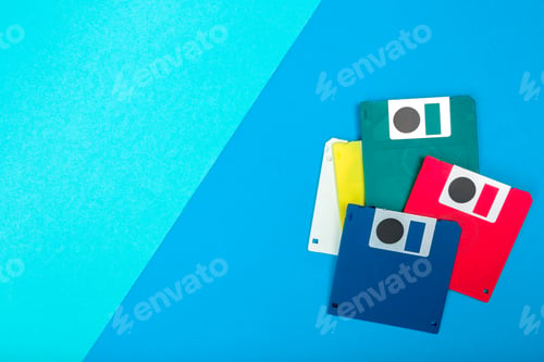 Preview: Colorful floppy disks arranged on a blue background showing retro technology from the past