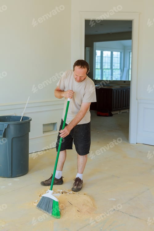 Preview: Handyman cleaning the window with squeegees in a new house