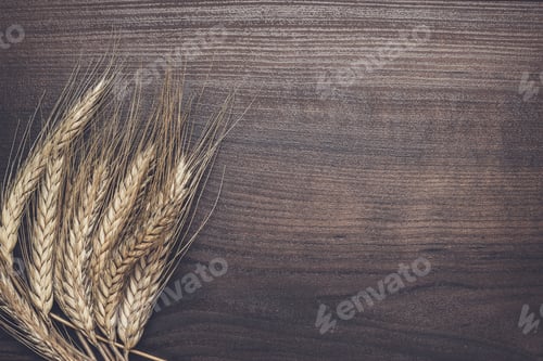 Preview: ears of rye over wooden background