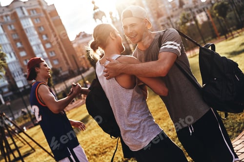 Preview: Friends forever. Group of young men in sports clothing gesturing and smiling while standing outdoors
