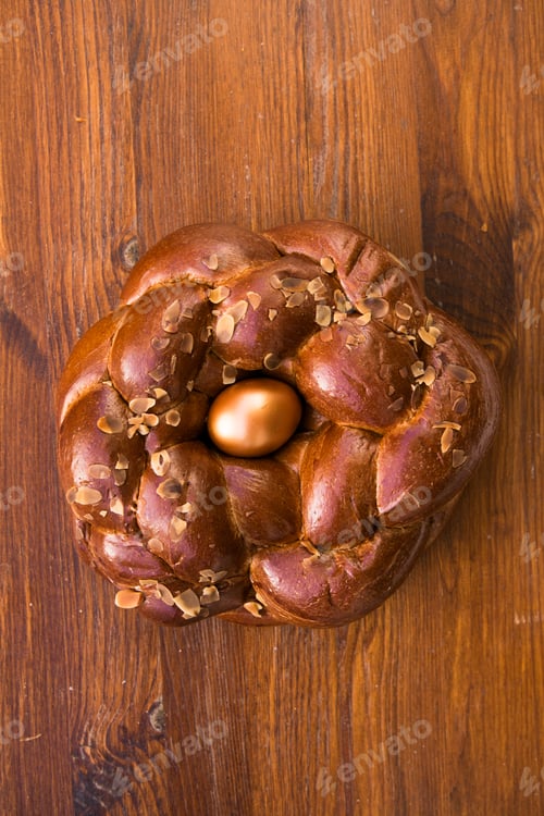 Preview: Tsoureki traditional baked Greek Easter sweet bread, with a boiled red dyed egg in the middle