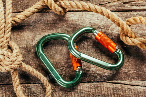 Preview: Climbing rope and carabiner on wooden board