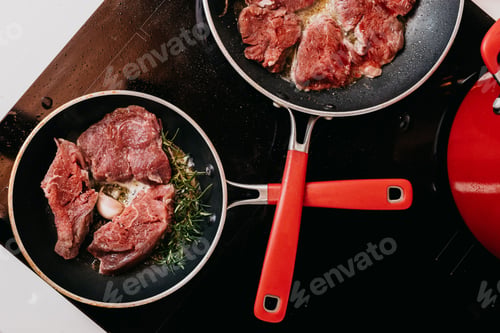 Preview: Of two metal pans filled with cooked meat