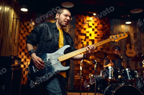Preview: Brutal musician with electric guitar on stage