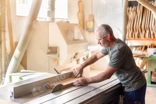 Preview: Man Using Table Saw in Woodworking Shop