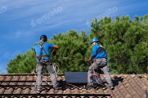 Preview: Technicians installing solar panels in a house