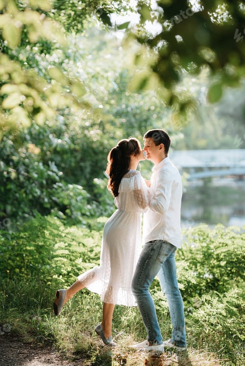 Preview: guy and a girl walk along the paths of a forest park