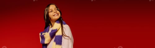 Preview: Little girl joyfully celebrates Christmas in vibrant scarf and festive spirit in 2025
