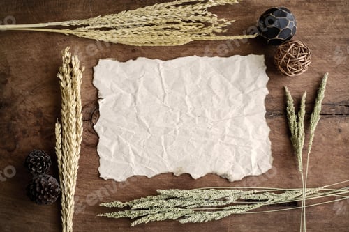 Preview: old wrinkld paper on old wood background with dried flower and c