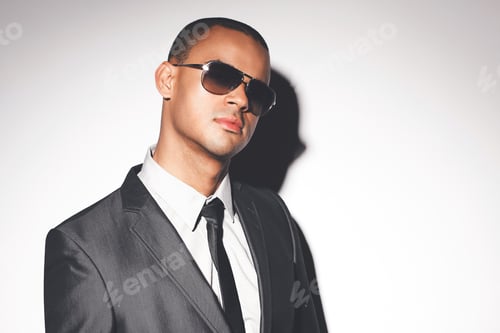 Preview: Man fashion model posing against a studio background