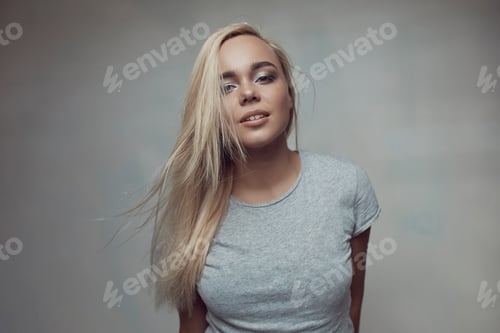 Preview: Pretty blonde woman posing in light room
