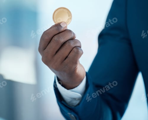 Preview: Its so much more than just a coin. Shot of a businessman holding a bitcoin in a modern office.
