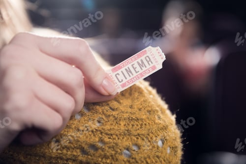 Preview: cropped view of woman holding cinema ticket