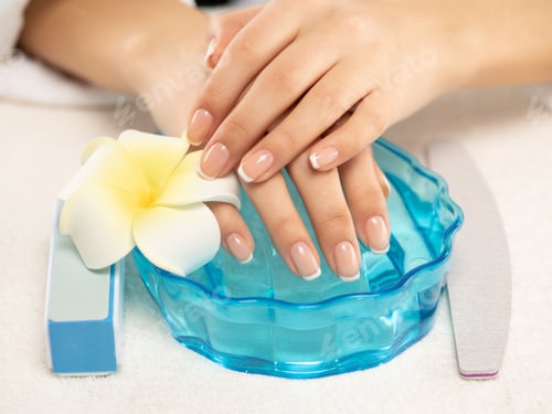 Preview: Woman gets manicure procedure in a spa salon. Beautiful female h