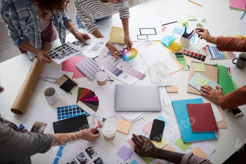 Preview: Creative Designer Team Discussing Production over Table