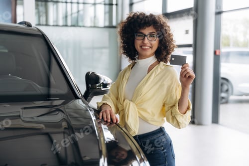 Preview: In casual clothes, standing by the vehicle. Pretty woman is in the car retail shop