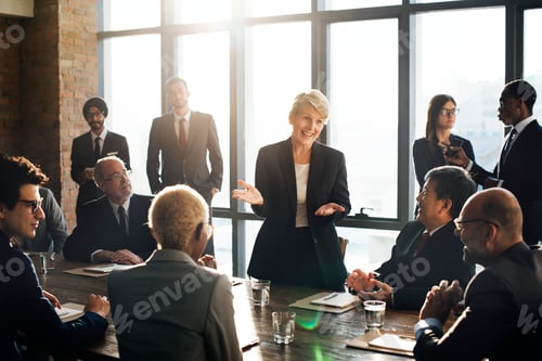 Preview: Business woman talking to colleagues in a meeting