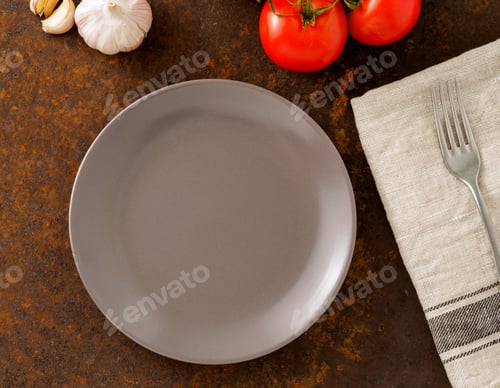 Preview: clean empty gray plate and fork on linen napkin on rusted old iron table