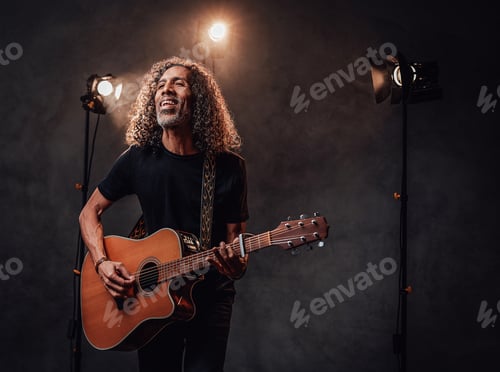 Preview: Man Singing and Playing Acoustic Guitar on Stage
