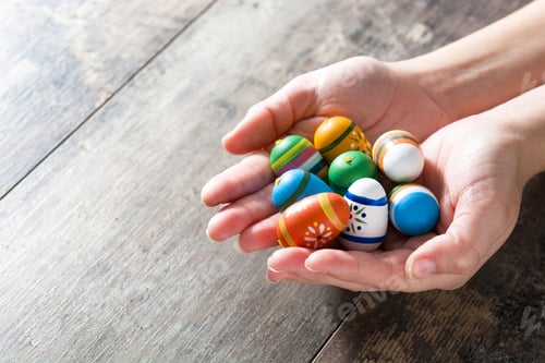 Preview: Woman holding colorful easter eggs in hands