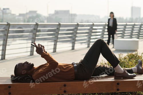 Preview: Man Relaxing On Bench