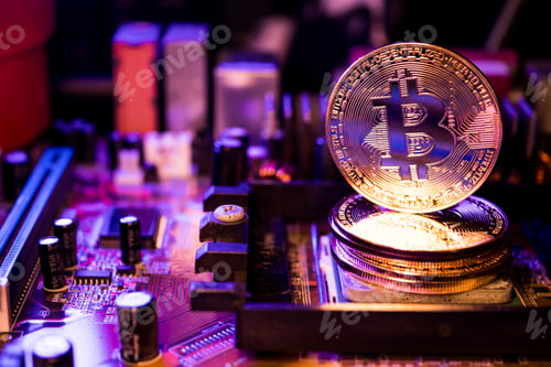 Preview: Golden coins with bitcoin symbol on a main board computer.