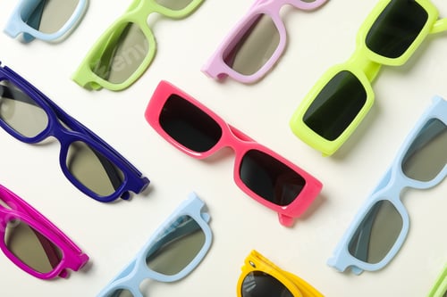 Preview: Colorful sunglasses on white background, top view