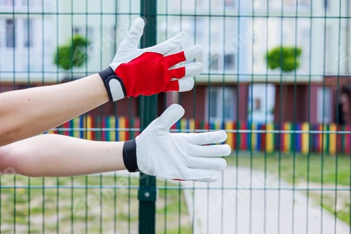 Preview: Close-up of male hands in construction gloves. Gloves for performing heavy dirty work