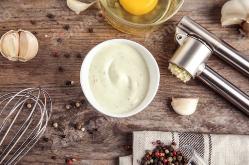 Preview: Flat lay composition with garlic sauce on wooden background