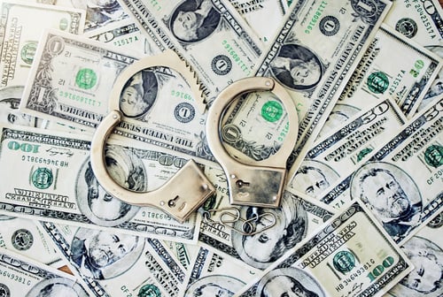 Preview: Bribe, corruption and money laundering with handcuffs on banknotes and jail time for corrupt busine