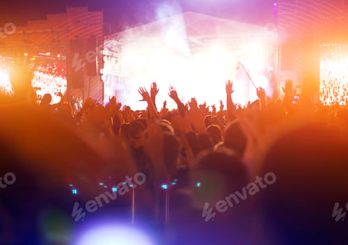 Preview: Silhouettes of concert crowd in front of bright stage lights