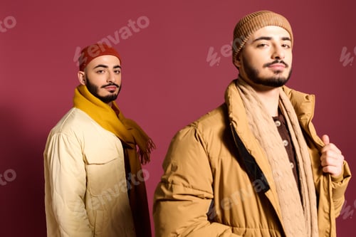 Preview: Stylish twin brothers showcase modern fashion against a vibrant backdrop