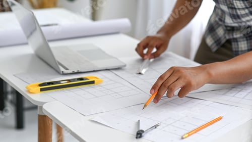 Preview: Architect hand held a pencil and ruler examining the house plan,Architect was designing the house.