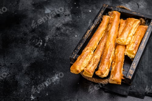 Preview: Bread sticks with cheese and salt. black background. top view