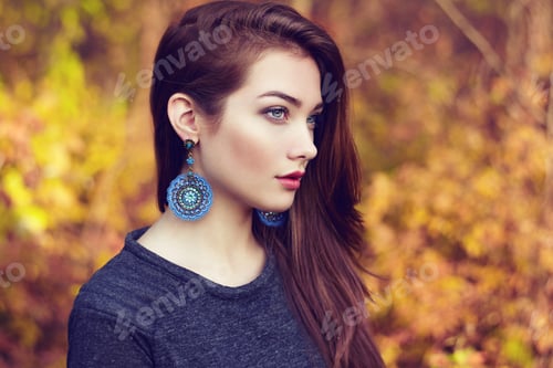 Preview: Portrait of young beautiful woman in autumn park