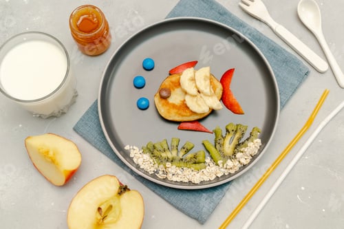 Preview: Funny fish face shape snack from pancake,apples on plate. Cute kids childrens baby's breakfast