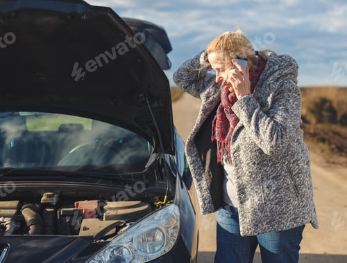 Preview: Senior woman on the road having engine failure, she is calling for assistance.