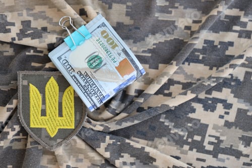 Preview: Ukrainian army symbol and bunch of dollar bills on military uniform
