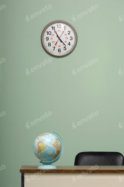 Preview: Vertical shot of the globe on the table and a clock hanging on the wall