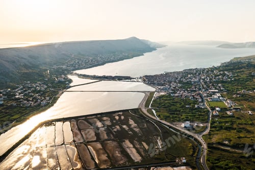 Preview: Aerial view of vast coastal salt pans with seawater pools and salt production