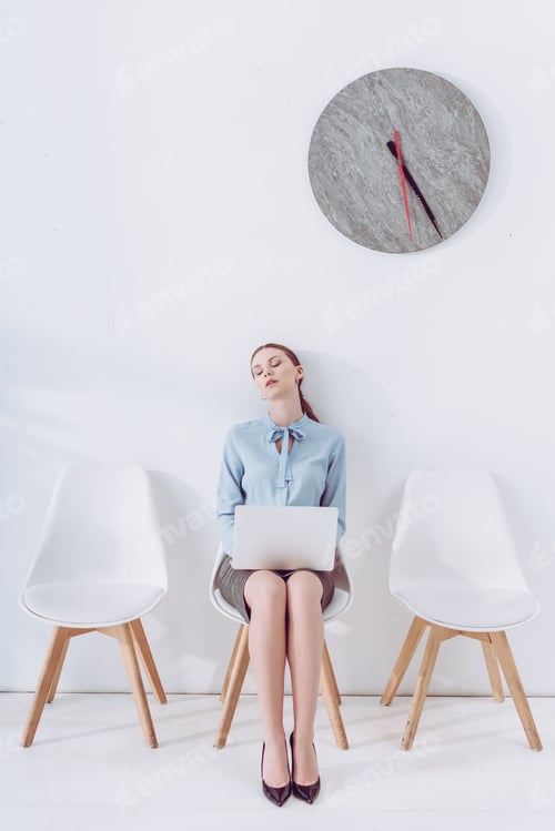 Preview: attractive woman with laptop sleeping on chair while waiting job interview