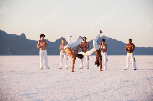 Preview: Team clapping man performing capoeira on Bonneville Salt Flats, Utah, USA