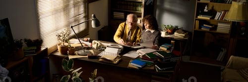 Preview: Senior Caucasian Man Teaching Young Adult Caucasian Woman in Library Office