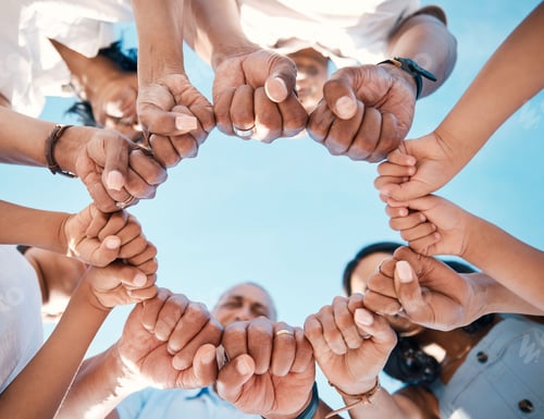 Preview: Circle, hands and fist bump by people in support of collaboration, motivation and goal from below.