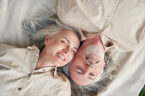 Preview: Joyful mature loving couple having rest outside