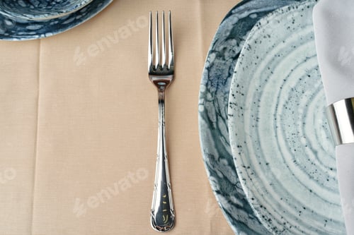 Preview: Details of a stylish table setting with textured ceramic dishes