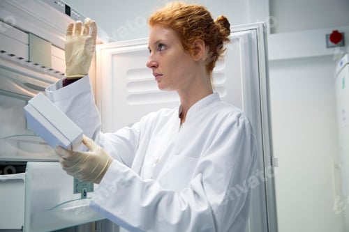 Preview: Young female natural scientist controlling a test in biochemistry laboratory