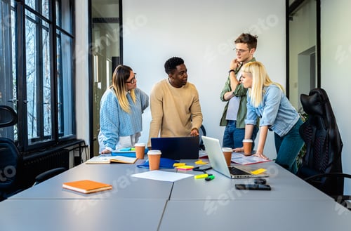 Preview: Diverse group of young people working on new project together in office.