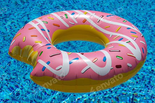 Preview: pink inflatable donut doughnut floating mattress in swimming pool. Beach accessories. Summer holiday